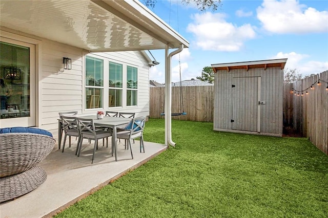 view of yard featuring a fenced backyard, a patio area, a storage unit, and an outdoor structure