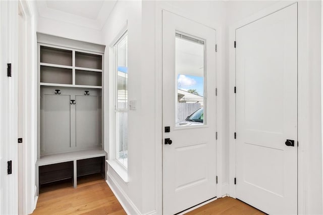 mudroom featuring light wood-style flooring and baseboards