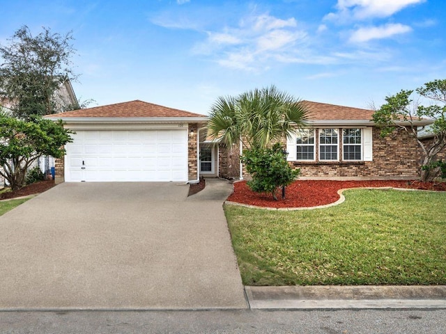 ranch-style house featuring a front yard and a garage