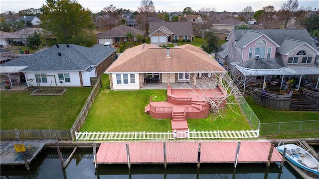 rear view of property with a deck and a yard