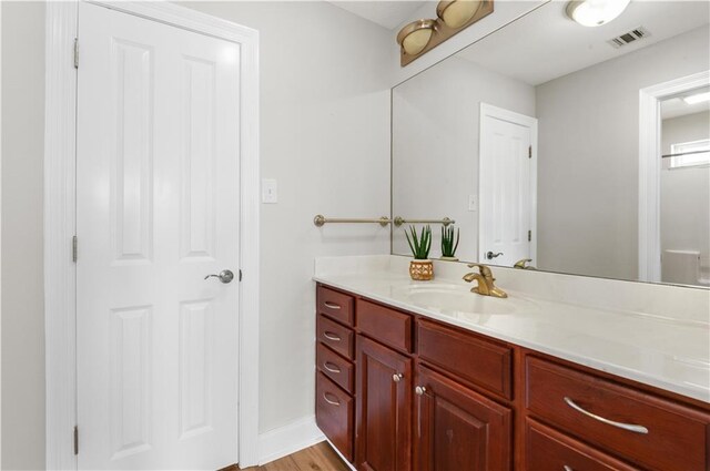 bathroom featuring vanity and hardwood / wood-style floors