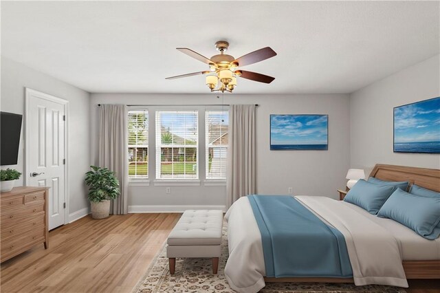 bedroom featuring ceiling fan and light hardwood / wood-style flooring