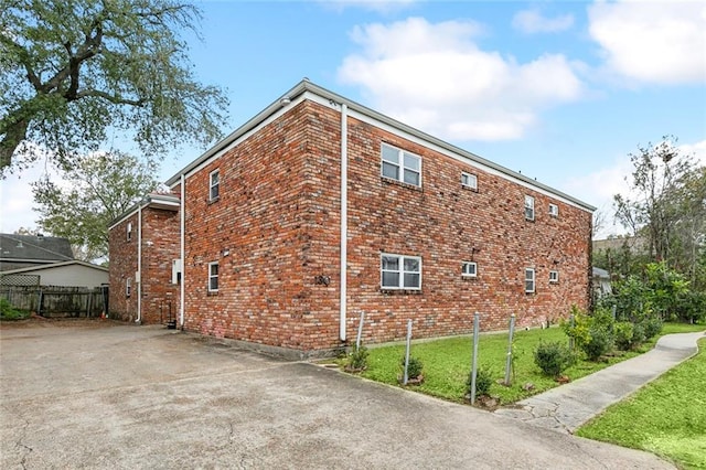 view of property exterior featuring a lawn