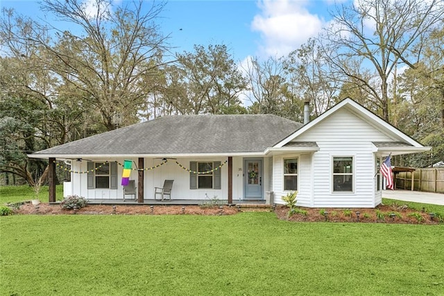 single story home with a front yard, covered porch, and a carport