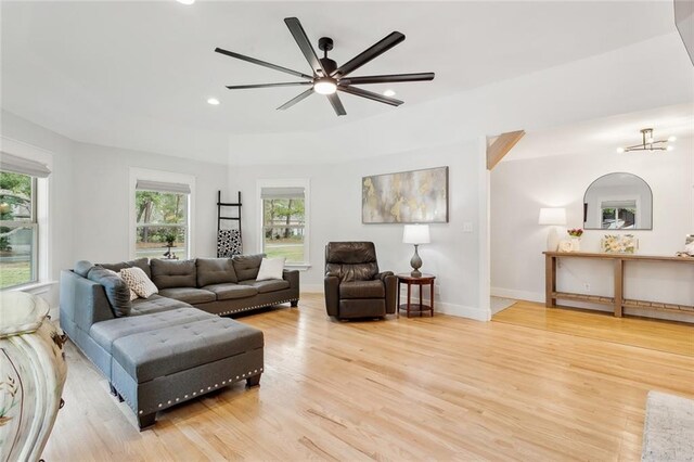 living room with ceiling fan and wood-type flooring