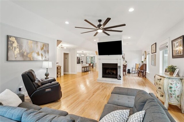 living room with ceiling fan and light wood-type flooring