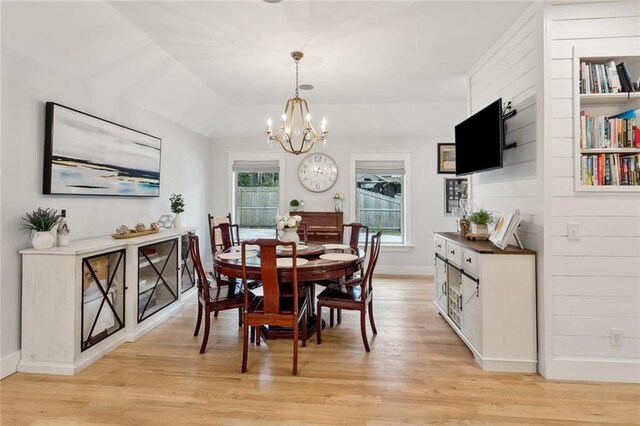 dining area with a chandelier and light hardwood / wood-style flooring