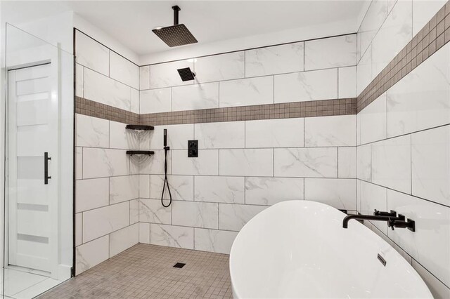 bathroom with tile walls and separate shower and tub