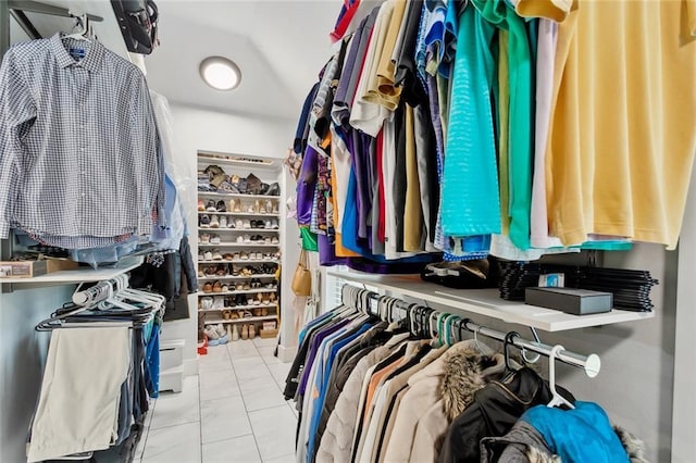 walk in closet featuring light tile patterned flooring