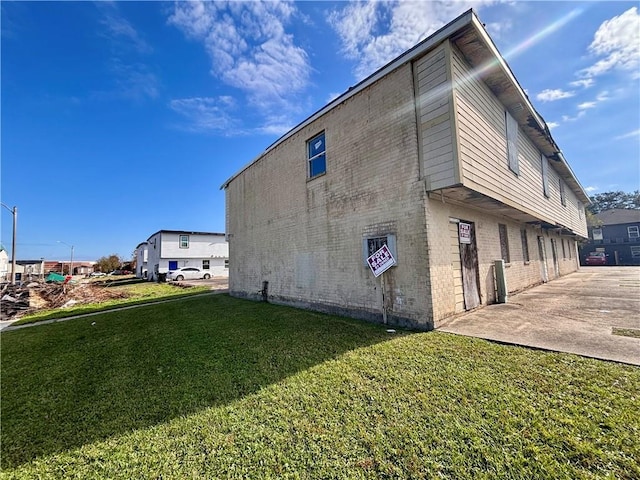 view of side of property with a yard