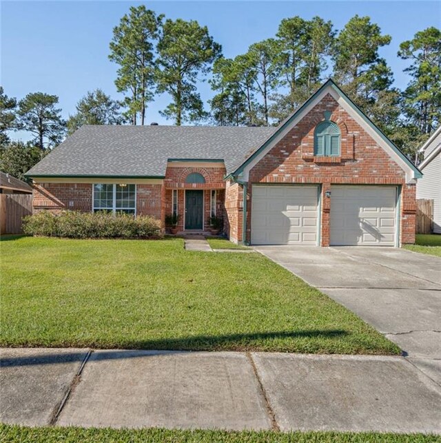 view of front of property with a garage and a front yard