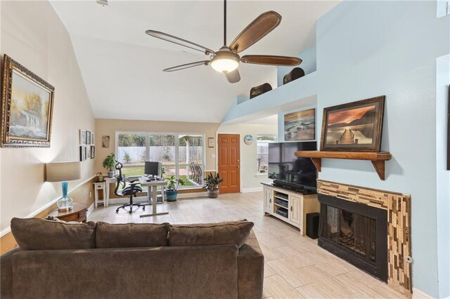 living room with ceiling fan and high vaulted ceiling