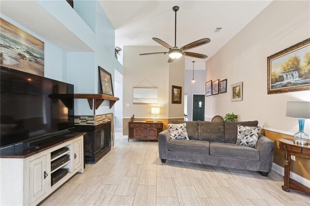 living room featuring ceiling fan and high vaulted ceiling