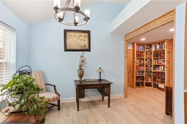 sitting room with a notable chandelier and light hardwood / wood-style floors