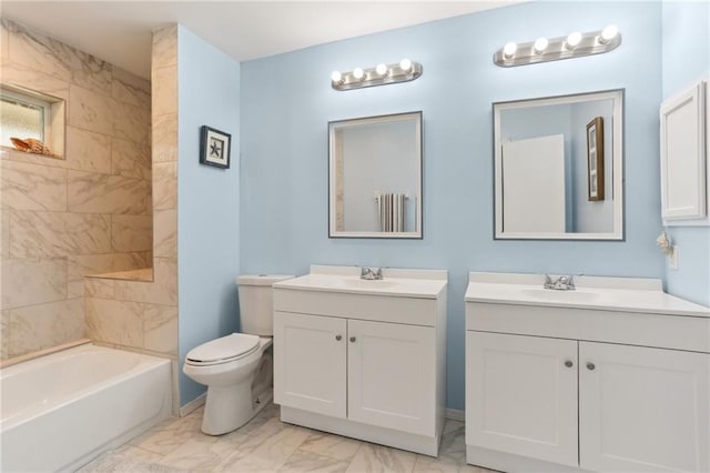 full bathroom featuring toilet, vanity, and tiled shower / bath