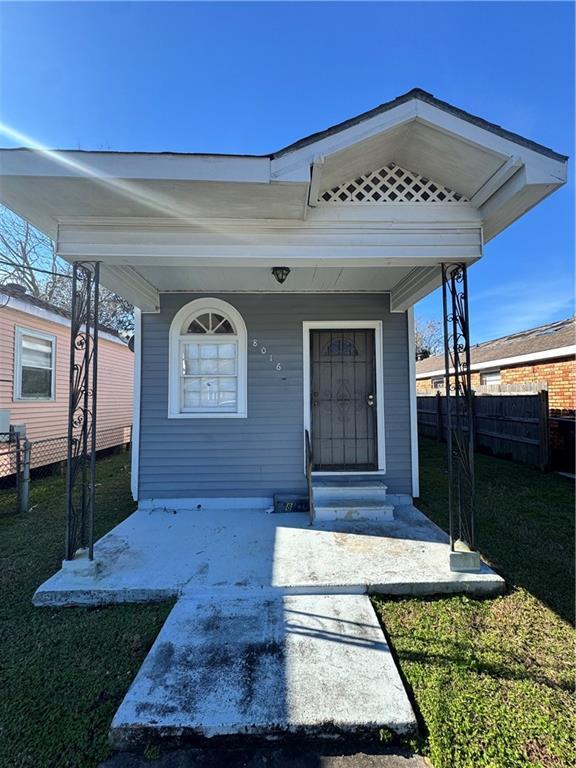 property entrance with a lawn