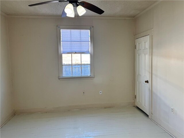 spare room with ceiling fan, a textured ceiling, and ornamental molding