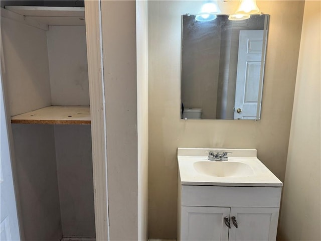 bathroom featuring toilet and vanity