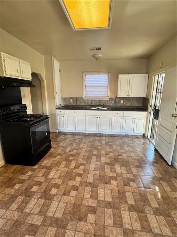 kitchen featuring white cabinets, black electric range, and sink