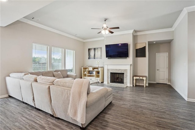 living room with dark wood-type flooring, ceiling fan, and crown molding