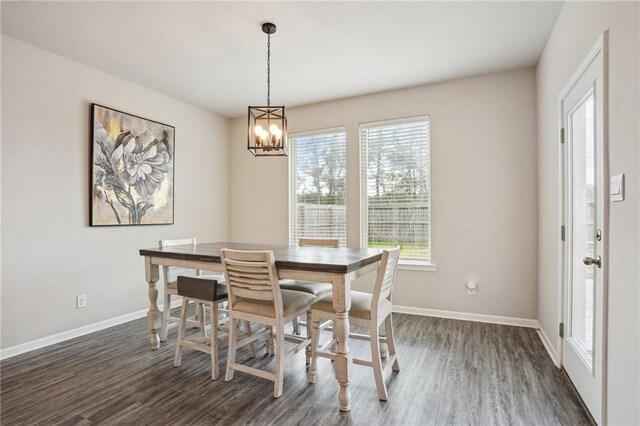 dining room featuring dark wood-type flooring and a notable chandelier