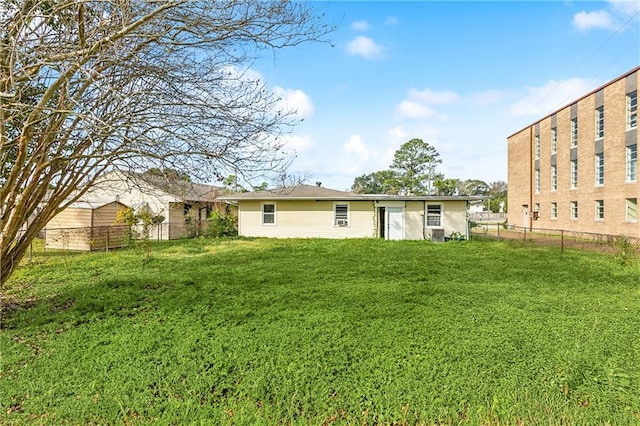 rear view of house featuring a lawn