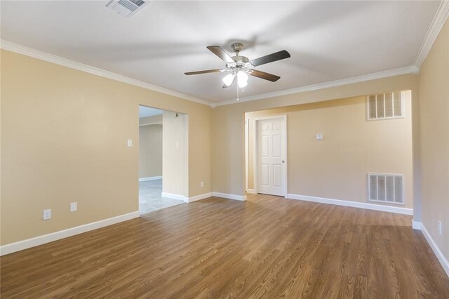 spare room featuring ceiling fan, hardwood / wood-style floors, and crown molding