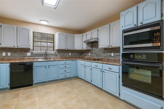 kitchen featuring white cabinetry, tasteful backsplash, blue cabinets, black appliances, and sink