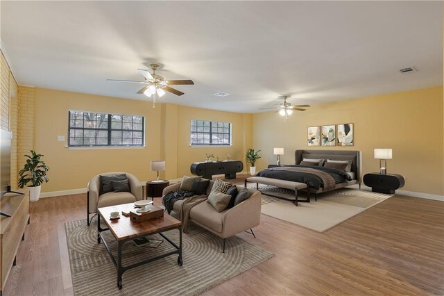 bedroom with ceiling fan and light hardwood / wood-style floors