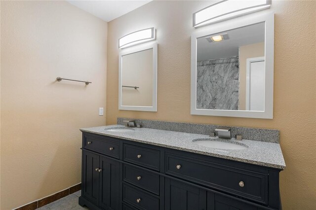 bathroom featuring tile patterned flooring and vanity