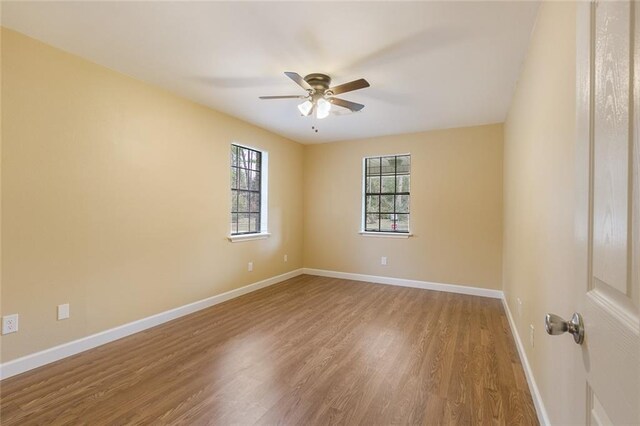 empty room featuring ceiling fan and wood-type flooring