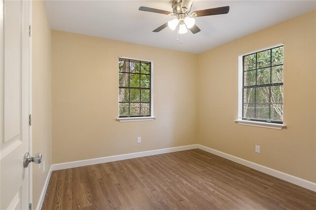 unfurnished room with hardwood / wood-style flooring, a wealth of natural light, and ceiling fan