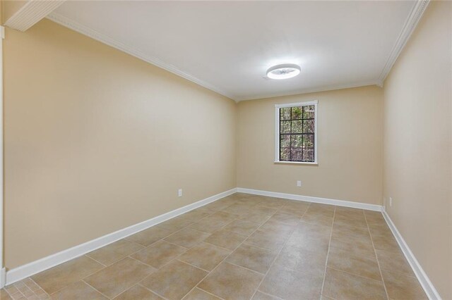 tiled spare room featuring ornamental molding