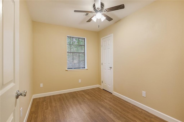 empty room with ceiling fan and wood-type flooring