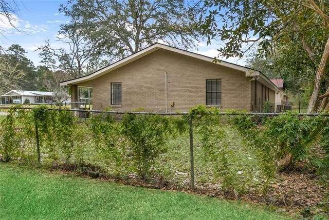 view of side of home featuring a lawn