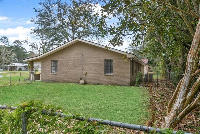 view of side of home with a lawn