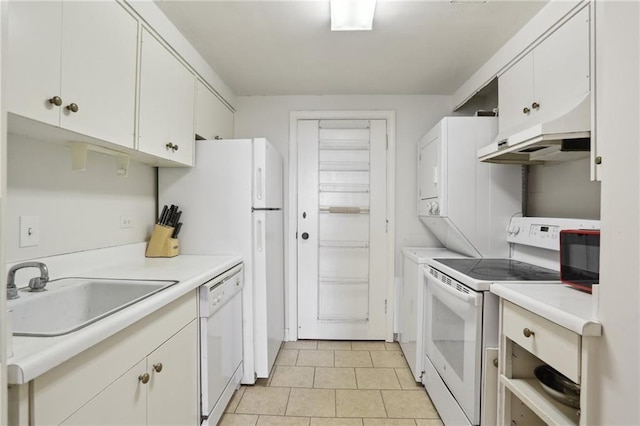 kitchen with light tile patterned floors, sink, white cabinets, and white appliances