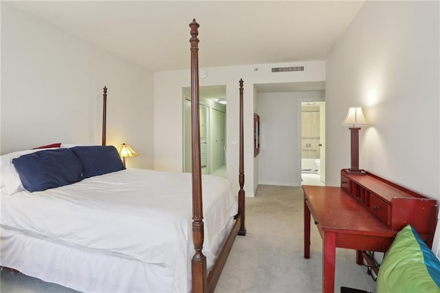 carpeted bedroom featuring connected bathroom