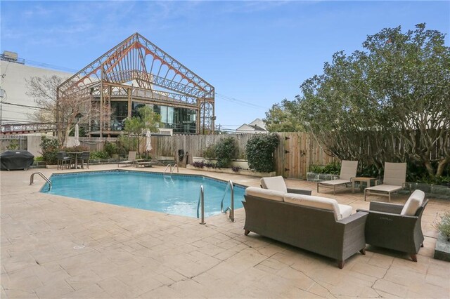 view of swimming pool featuring a patio area and area for grilling