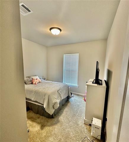 bedroom with light carpet