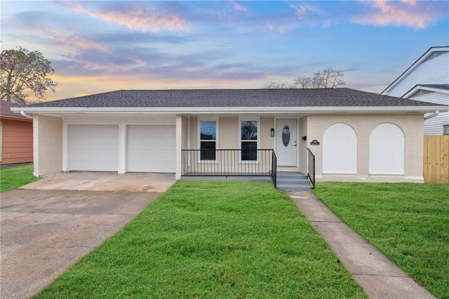 ranch-style house with a lawn, a porch, and a garage