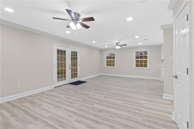 empty room with light hardwood / wood-style floors, ceiling fan, crown molding, and french doors