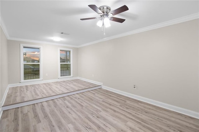 empty room featuring ceiling fan, light wood-type flooring, and crown molding