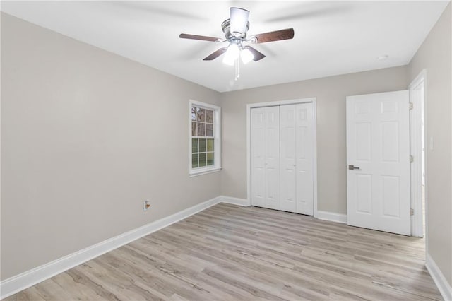 unfurnished bedroom featuring ceiling fan, a closet, and light hardwood / wood-style floors