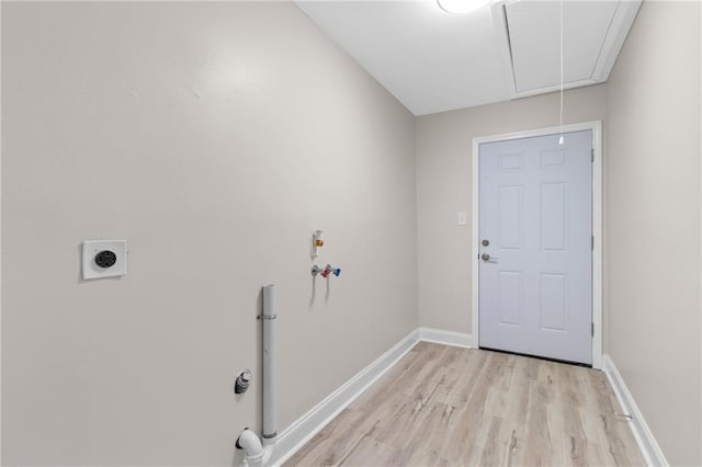 washroom featuring light hardwood / wood-style floors, washer hookup, and electric dryer hookup