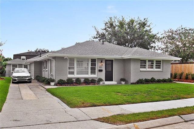 553 Crystal St, New Orleans, LA 70124 - single story home featuring brick siding, fence, a shingled roof, driveway, and a front yard