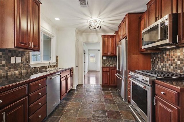 553 Crystal St, New Orleans, LA 70124 - kitchen with a sink, premium appliances, stone tile flooring, tasteful backsplash, and visible vents