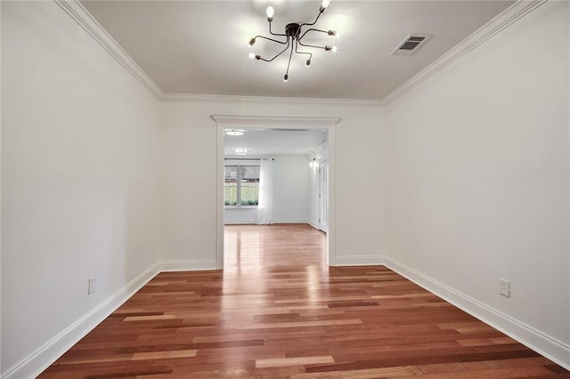 553 Crystal St, New Orleans, LA 70124 - unfurnished dining area with visible vents, wood finished floors, a notable chandelier, and ornamental molding