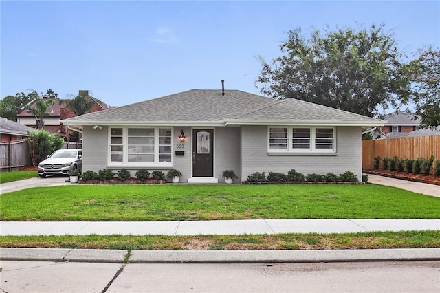 553 Crystal St, New Orleans, LA 70124 - view of front of home featuring brick siding, fence, and a front lawn