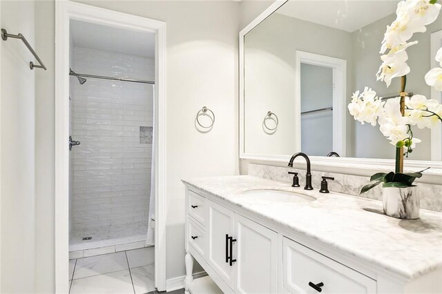 bathroom featuring vanity and a tile shower